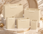 Beige textured paper gift bags with handles in several sizes
