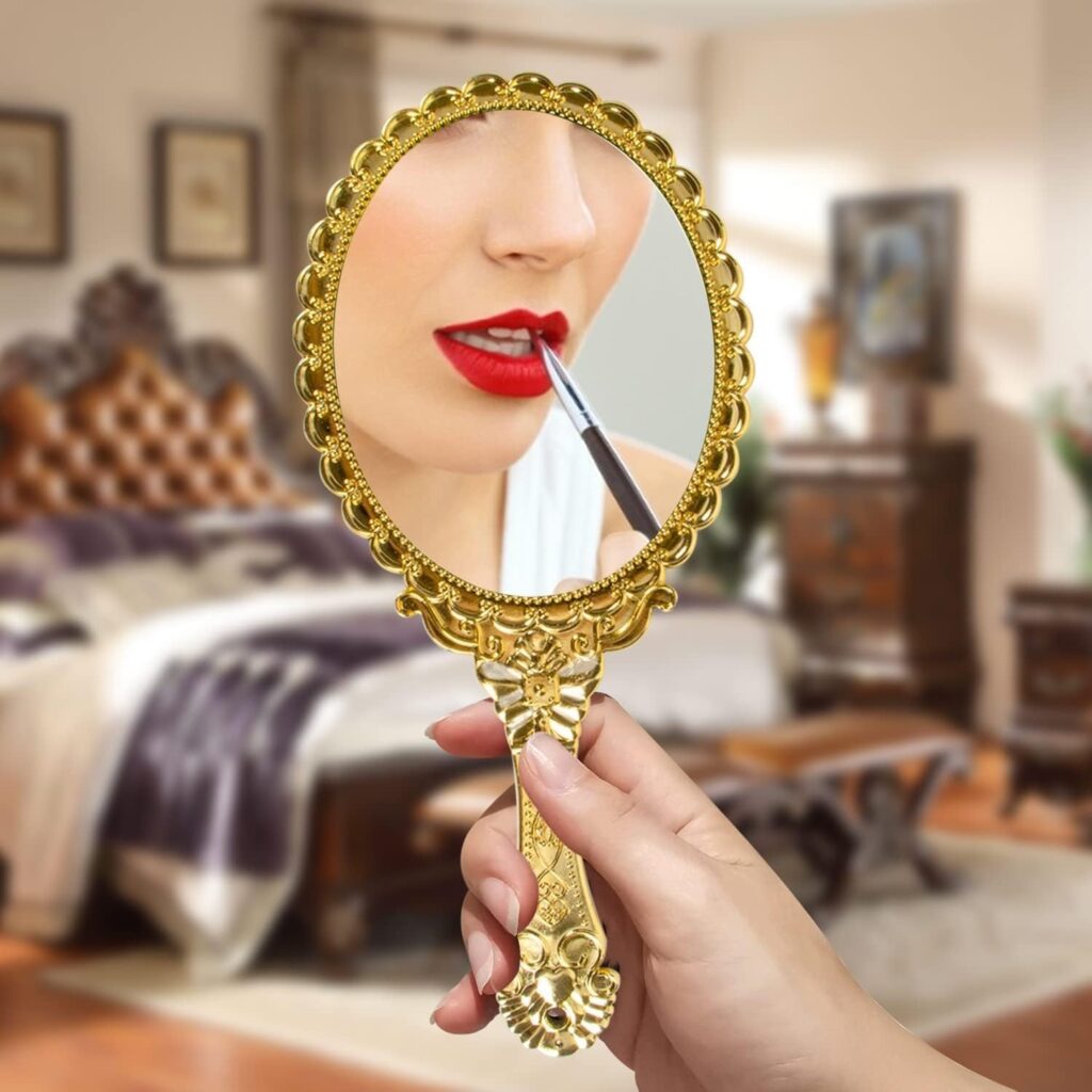 vintage handheld mirror with embossed flower design