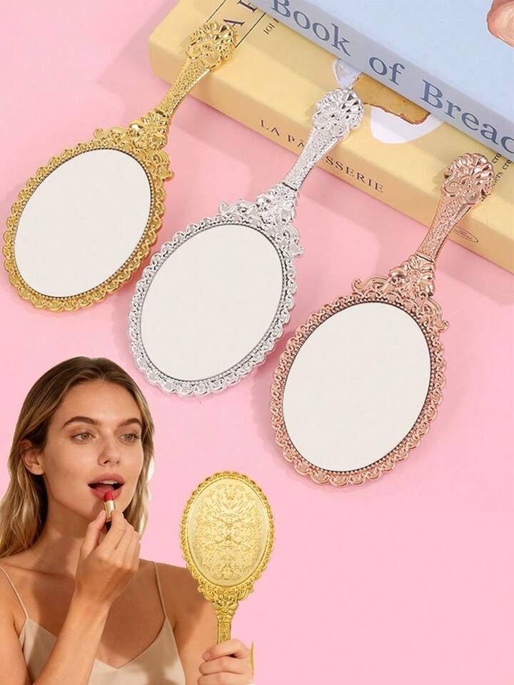 vintage handheld mirror with embossed flower design