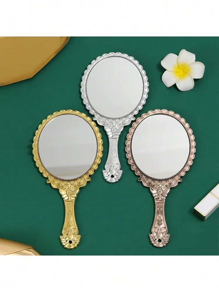vintage handheld mirror with embossed flower design