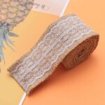 Burlap lace ribbon roll with white lace on natural brown jute